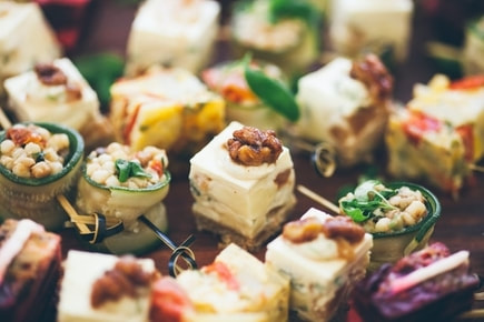 Picture of various hor d'oeuvres with toothpicks in them.
